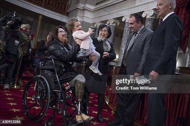 Vice President Joe Biden, right, talks with Sen. Tammy Duckworth, D-Ill., her mother Lamai, daughter Abigail and husband Bryan Bowlsbey, during...