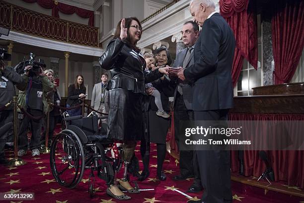 Vice President Joe Biden administers an oath to Sen. Tammy Duckworth, D-Ill., during swearing-in ceremony in the Capitol's Old Senate Chamber,...