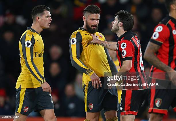 Harry Arter of Bournemouth pushes back Olivier Giroud of Arsenal as he has words with Granit Xhaka of Arsenal during the Premier League match between...