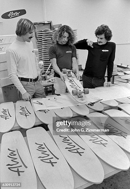 View of Tony Alva checking out skateboards during photo shoot in his shop. Venice, CA 1/1/1978 -- CREDIT: John G. Zimmerman