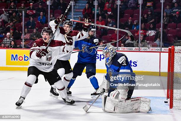 Rudolfs Balcers and teammate Erlends Klavins of Team Latvia react after a goal on goaltender Veini Vehvilainen of Team Finland during the 2017 IIHF...