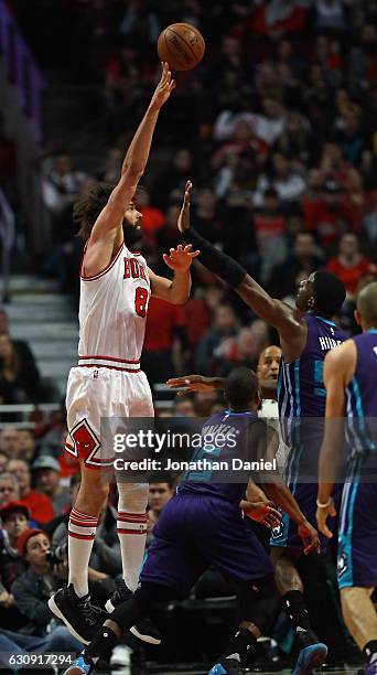 Robin Lopez of the Chicago Bulls puts up a hook shot over Roy Hibbert of the Charlotte Hornets at the United Center on January 2, 2017 in Chicago,...