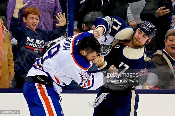 Brandon Dubinsky of the Columbus Blue Jackets throws a punch while fighting with Patrick Maroon of the Edmonton Oilers during the second period on...
