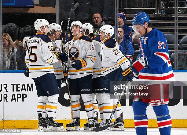 Ryan McDonagh of the New York Rangers reacts as Jack Eichel of the Buffalo Sabres is congratulated by his teammates after scoring a third period goal...