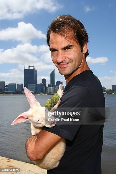 Roger Federer of Switzerland holds Casper, the kangaroo joey at the South Perth foreshore on December 30, 2016 in Perth, Australia.