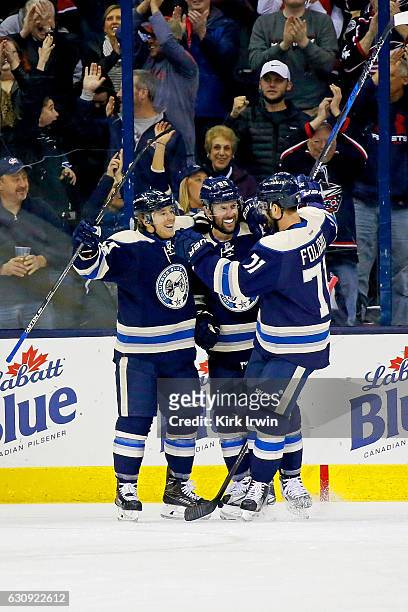 Sam Gagner and Nick Foligno of the Columbus Blue Jackets congratulate Cam Atkinson on his power play goal during the first period of the game against...