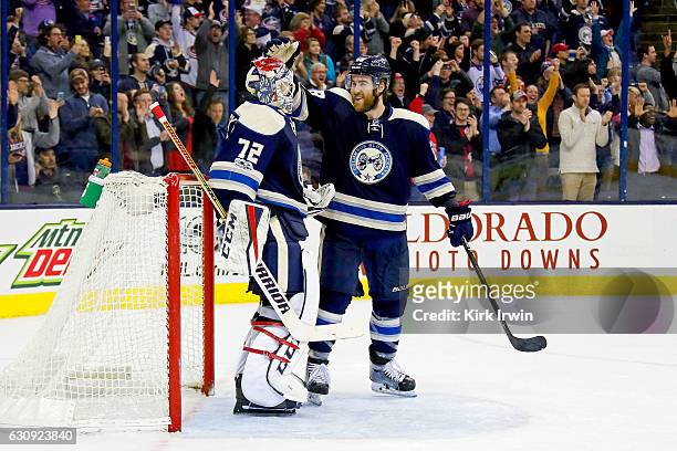 David Savard of the Columbus Blue Jackets congratulates Sergei Bobrovsky of the Columbus Blue Jackets after defeating the Edmonton Oilers 3-1 and...