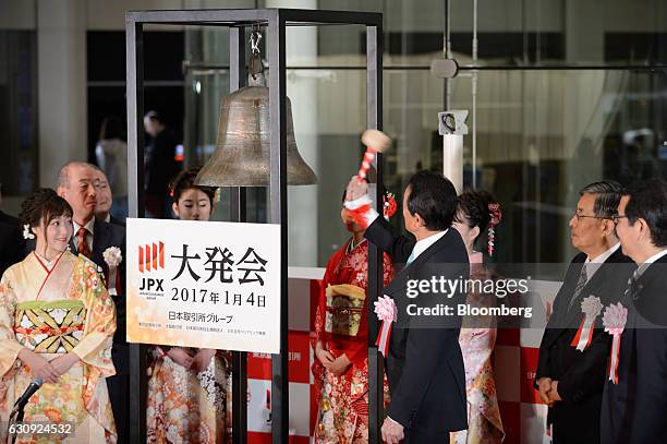 Taro Aso, Japan's finance minister, rings the opening bell during a ceremony marking the first trading day of the year at the Tokyo Stock Exchange ,...