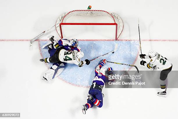 Forward JJ Piccinich of the London Knights battles for the puck against goaltender Michael DiPietro of the Windsor Spitfires on January 3, 2017 at...