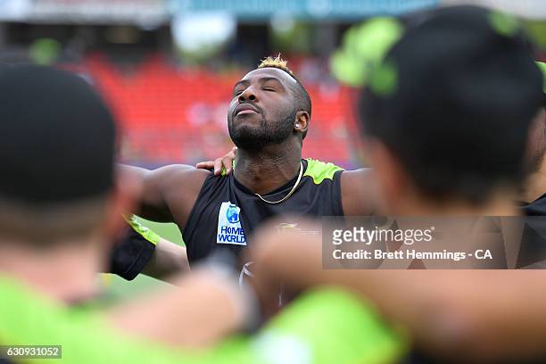 Andre Russell of the Thunder looks on during a team huddle prior to the Big Bash League match between the Sydney Thunder and Melbourne Stars at...