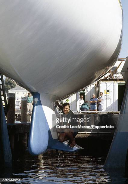 Marine architect Ben Lexcen perched on the revolutionary new keel that he designed for Australia II prior to the America's Cup series in Newport,...