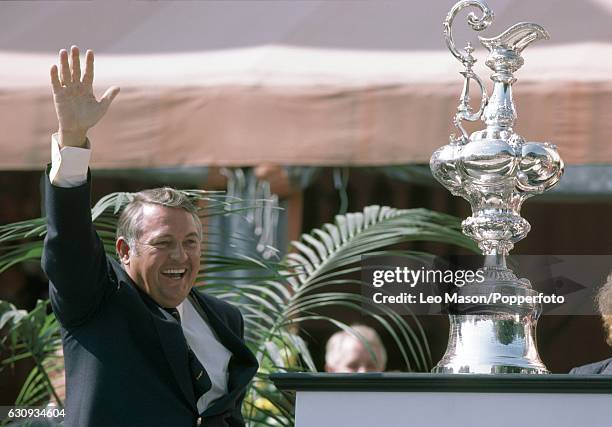 Alan Bond, the Australian businessman and leader of the syndicate which owned the victorious Australia II, celebrates during the presentation...