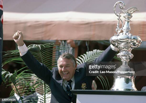Alan Bond, the Australian businessman and leader of the syndicate which owned the victorious Australia II, celebrates during the presentation...