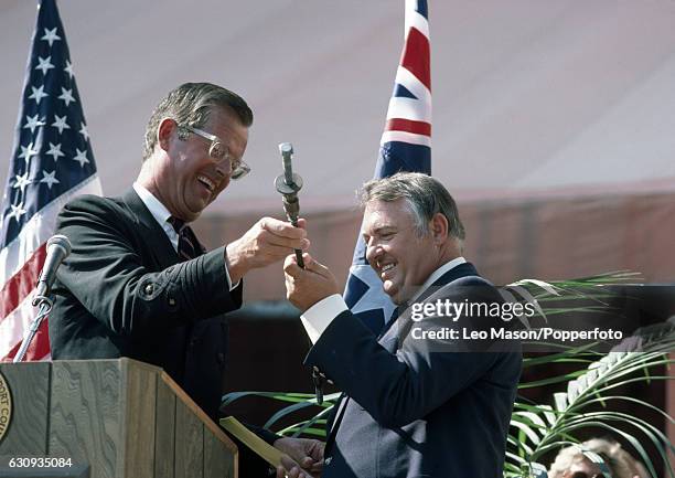 Alan Bond , the Australian businessman and leader of the syndicate which owned the victorious Australia II, receives the bolt which had held the...