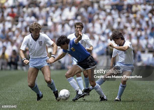 Jorge Burruchaga of Argentina in action against Steve Hodge and Terry Butcher of England during the World Cup Quarter-Final match between England and...