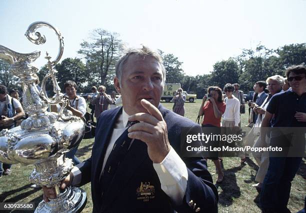 Alan Bond, the Australian businessman and leader of the syndicate which owned the victorious Australia II, with the trophy after the presentation...