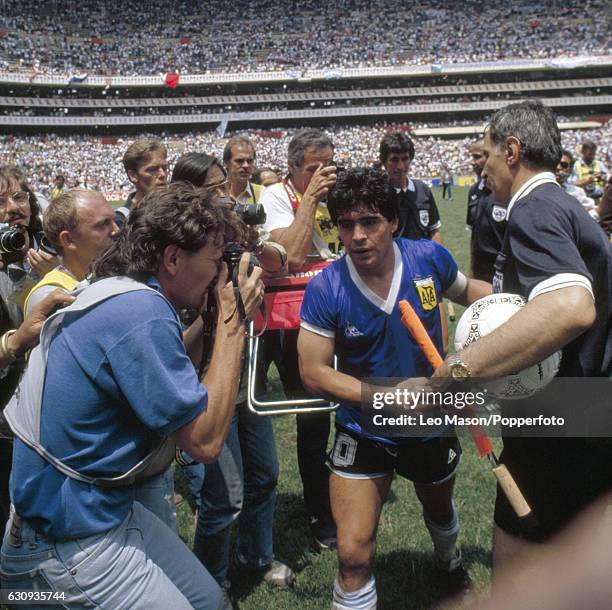 Diego Maradona of Argentina shakes hands with linesman Bogdan Dotchev who had been closest to the Hand of God when Maradona scored the 1st goal with...