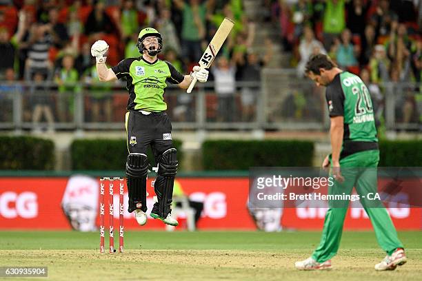 Eoin Morgan of the Thunder celebrates hitting a six to win the match during the Big Bash League match between the Sydney Thunder and Melbourne Stars...
