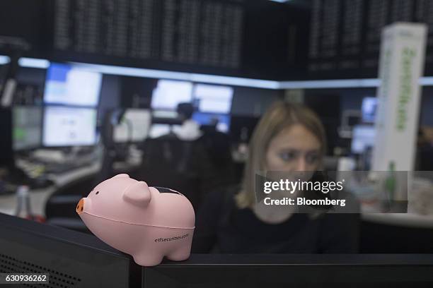 Pig figurine sits on a trader's desk inside the Frankfurt Stock Exchange in Frankfurt, Germany, on Wednesday, Jan. 4, 2017. U.S. Unilateralism under...