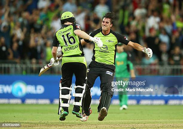 Eoin Morgan of the Thunder and Pat Cummins of the Thunder celebrate victory after winning the Big Bash League match between the Sydney Thunder and...