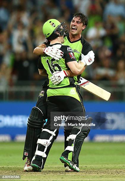 Eoin Morgan of the Thunder and Pat Cummins of the Thunder celebrate victory after winning the Big Bash League match between the Sydney Thunder and...