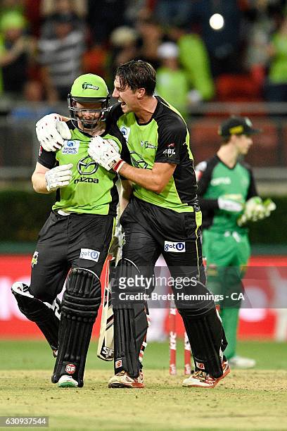 Eoin Morgan of the Thunder and Pat Cummins of the Thunder celebrate after victory during the Big Bash League match between the Sydney Thunder and...