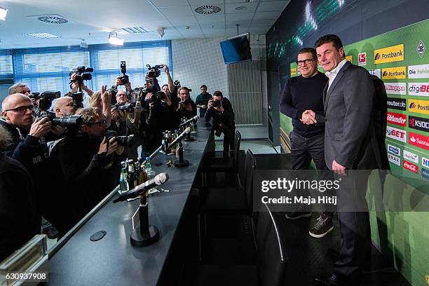 Sport Director Max Eberl of Moenchengladbach and Dieter Hecking, the newly appointed head coach of Borussia Moenchengladbach shake hands prior a...