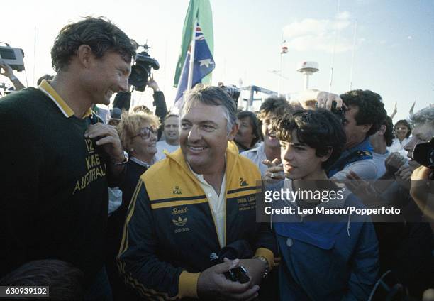 Alan Bond, the Australian businessman and leader of the syndicate which owned the victorious Australia II, celebrates with skipper Jean Bertrand...