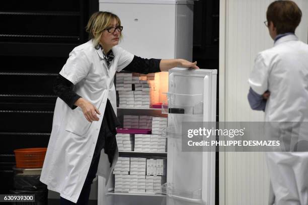 Nurses stand next to a fridge containing vaccins against meningitis on January 4, 2017 at the University of Dijon. Thirty thousand people are invited...