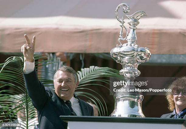 Alan Bond, the Australian businessman and leader of the syndicate which owned the victorious Australia II, celebrates during the presentation...