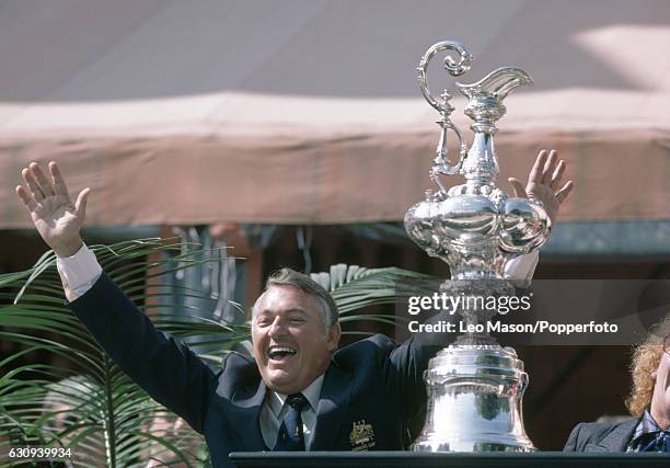 Alan Bond, the Australian businessman and leader of the syndicate which owned the victorious Australia II, celebrates during the presentation...