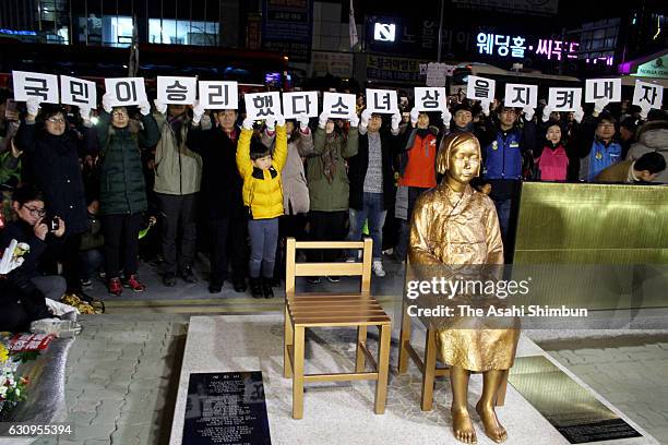 Statue of a girl symbolising Korean "comfort women" is unveiled during the unveiling ceremony in front of the Japanese consulate-general on December...