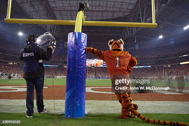 Fiesta Bowl: Rear view of Clemson Tiger mascot and ESPN cameraman on field at goalpost during game vs Ohio State at University of Phoenix Stadium....