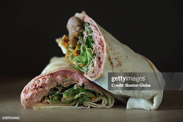 Beet hummus wrap with chicken, carrots and lettuce is pictured at Tahaza Hummus Kitchen in Cambridge, MA on Nov. 21 2015.