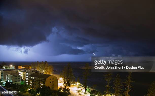 storm clouds over a city - caloundra stock pictures, royalty-free photos & images