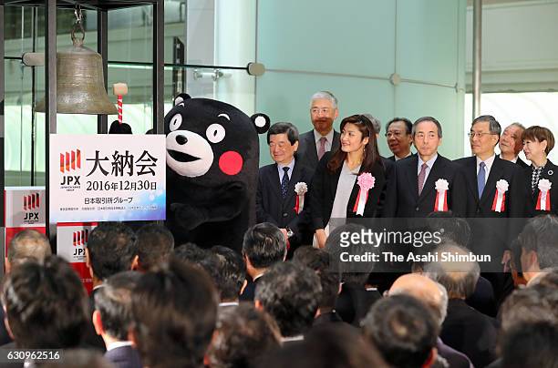 Kumamoto Prefecture mascot Kumamon rings a bell during the closing ceremony to mark the end of the year's trading at the Tokyo Stock Exchange on...