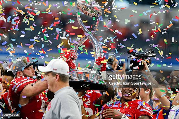 Wisconsin Badgers running back Corey Clement lifts the 81st Annual Cotton Bowl Trophy after the Goodyear Cotton Bowl Classic between Western Michigan...