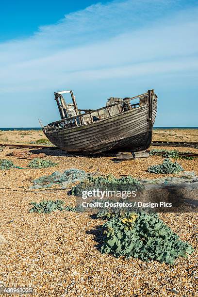 old boat on dungeness shingle beach - dungeness stock pictures, royalty-free photos & images