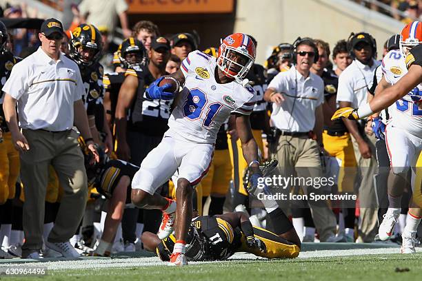 Antonio Callaway of the Gators breaks a tackle along the Iowa sideline during the Outback Bowl game between the Florida Gators and the Iowa Hawkeyes...