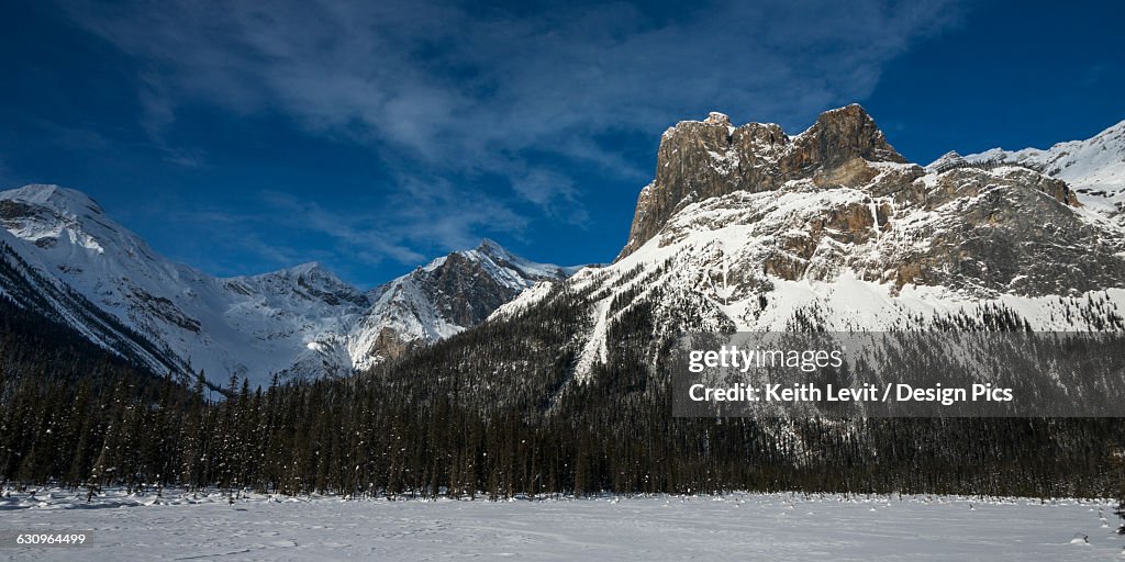 Snow on the rugged Canadian Rocky Mountains and a snow covered field, Yoho National Park