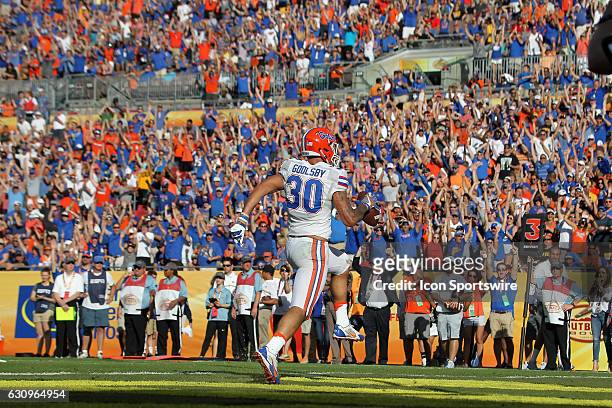 Florida Gators tight end DeAndre Goolsby celebrates after catching a pass in the end zone for a touchdown as the Gator fans stand in unison to cheer...