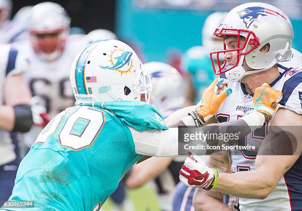 Miami Dolphins Cornerback Tony Lippett blocks New England Patriots Wide Receiver Chris Hogan during the NFL football game between the New England...