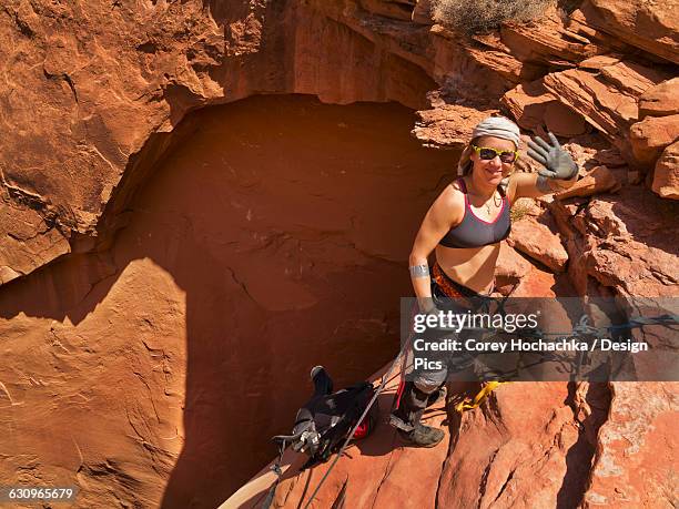 female adventurer exploring a desert slot canyon, san rafael swell - san rafael desert stock pictures, royalty-free photos & images
