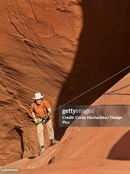 adventurer exploring a desert slot canyon, san rafael swell - san rafael desert stock pictures, royalty-free photos & images