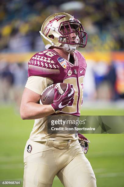 Florida State Seminoles Tight End Eric Johnson runs with ball on the field before the start of the NCAA Capital One Orange Bowl football game between...