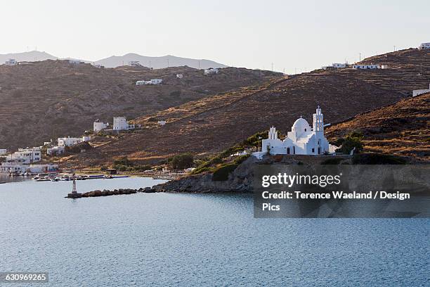 port and white church on a cliff at the waters edge - terence waeland stock-fotos und bilder