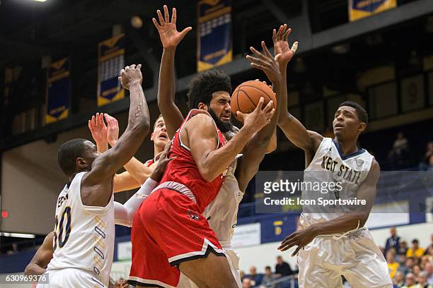 Ball State Cardinals C Trey Moses grabs a rebound surrounded by Kent State Golden Flashes G Deon Edwin , Kent State Golden Flashes F Jimmy Hall , and...
