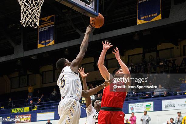 Kent State Golden Flashes F Danny Pippen deflects the shot of Ball State Cardinals G Tayler Persons during the second half of the NCAA Men's...