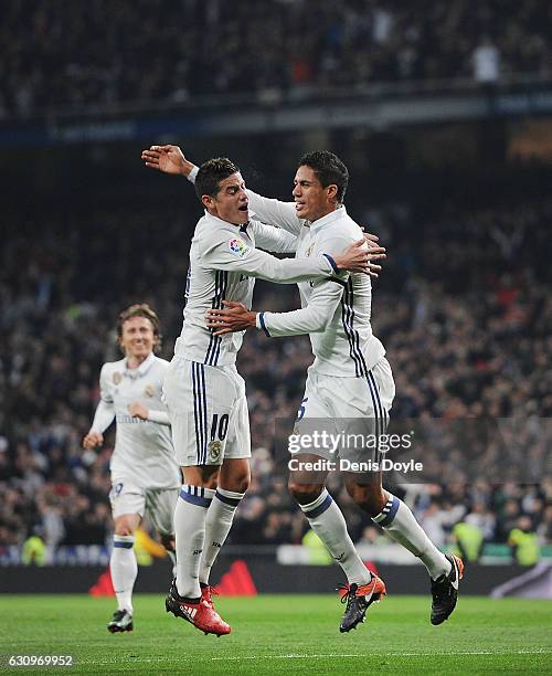 Rafael Varane of Real Madrid celebrates with James Rodriguez after scoring Real's 2nd goal during the Copa del Rey Round of 16 First Leg match...