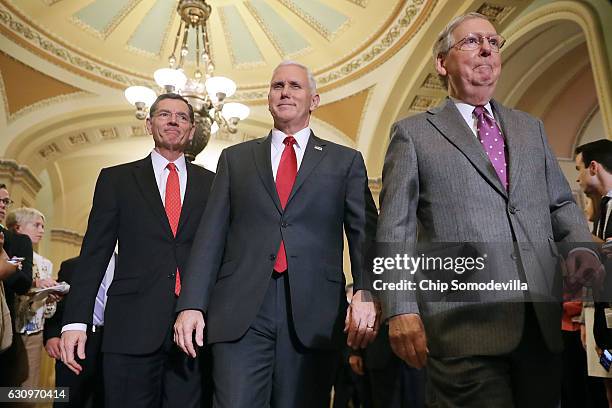Vice President-elect Mike Pence , Senate Majority Leader Mitch McConnell and Sen. John Barrasso arrive for a news conference in the U.S. Capitol...